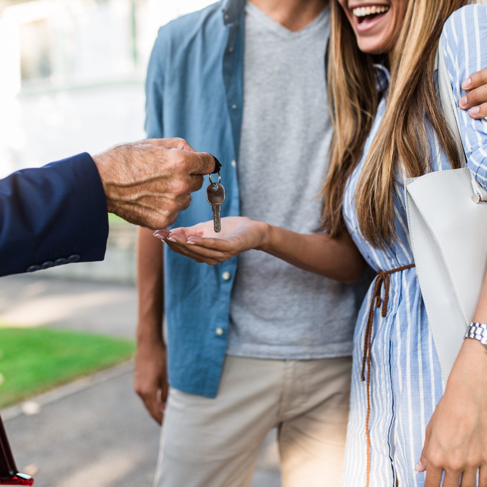 Young happy couple talking with real estate agent and buying a new house.